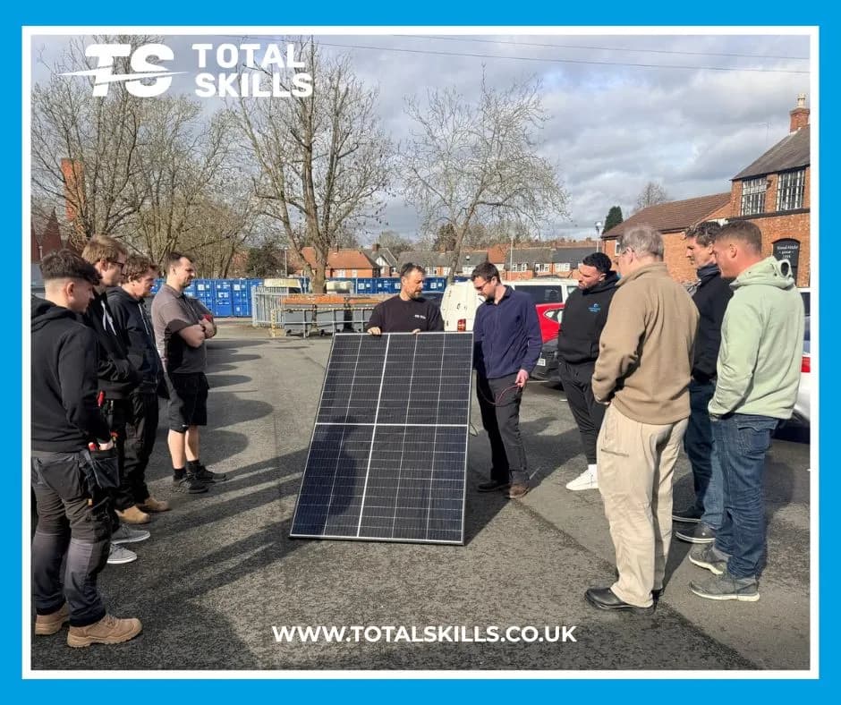 Students handling solar PV panels outdoors at Total Skills Nottingham training centre